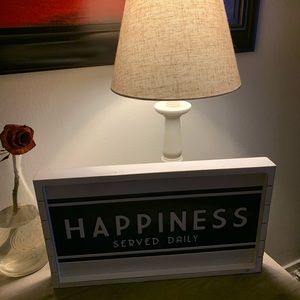 Metal embossed sign set in whitewashed wood